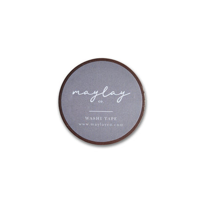The Tang Washi Tape from Maylay Co. is a round, flat roll of decorative tape featuring a gray label with white text that reads "may lay co. WASHI TAPE www.maylayco.com." It's perfect for scrapbooking projects and is photographed against a plain white background.