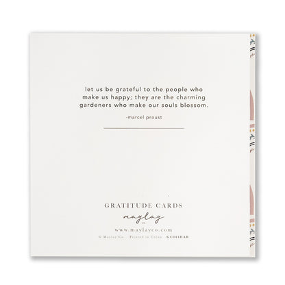A greeting card featuring a quote by Marcel Proust: "Let us be grateful to the people who make us happy; they are the charming gardeners who make our souls blossom." This Thank You card from Maylay Co.'s Happy Rainbows Gratitude Greeting Cards line boasts decorative patterns on the side.